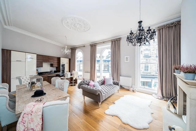 Floor to ceiling arched windows give amazing views and light up the room in this Harrogate flat .