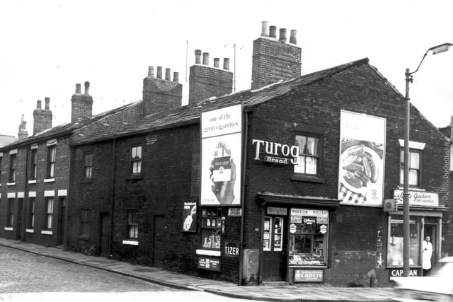 A small grocers on the corner of Scalby Street, and right Leslie Jackson, gent's hairdresser in February 1964. The man in a white coat standing in the doorway may have been the proprietor. A glimpse of Whitby Street can be seen to the far right.