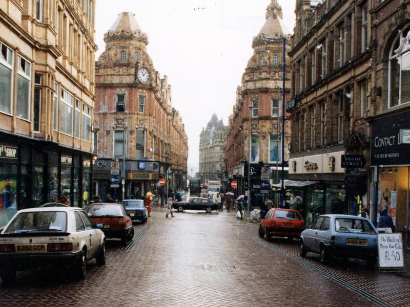 Albion Place looking east towards the junction with Briggate and King Edward Street. On the left is the Body Shop cosmetics, with Dunn & Co, menswear across the road. On the right is Peter Millican, opticians, then Brook Street Bureau employment agency and Saxone footwear, with Debenhans department store beyond the junction.