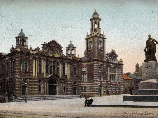 A colour-tinted postcard of Oxford Place Methodist Chapel with a postmark of August 5, 1907. The view looks across Victoria Square at the front of the Town Hall, past the statue of Robert Peel on the right. The original chapel on Oxford Place had been built in 1835 but by 1896 had become inadequate for the growing population, so work began on new premises designed by Danby & Thorpe of Leeds. Despite suffering fire damage in 1911 this church survives to this day and is now a listed building.