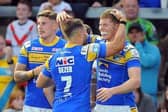 Liam Sutcliffe, left and Richie Myler congratulate Morgan Gannon on his try against Warrington. Picture by John Rushworth/SWpix.com.