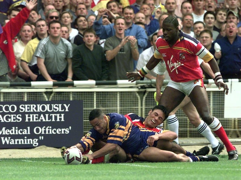 London's Martin Offiah watches as Rhinos' Leroy Rivett touches down.