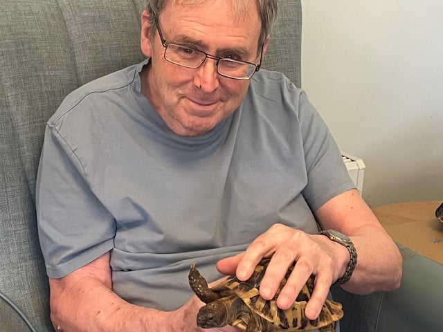 Resident from HC-One’s April Park Care Home with tortoise from Leanimals Petting Zoo