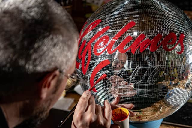 Mirrorball artist and signwriter Kieran Hadley working in his studio in Leeds on a miirorball for American singer, songwriter, Katy Perry Photograph by Tony Johnson.