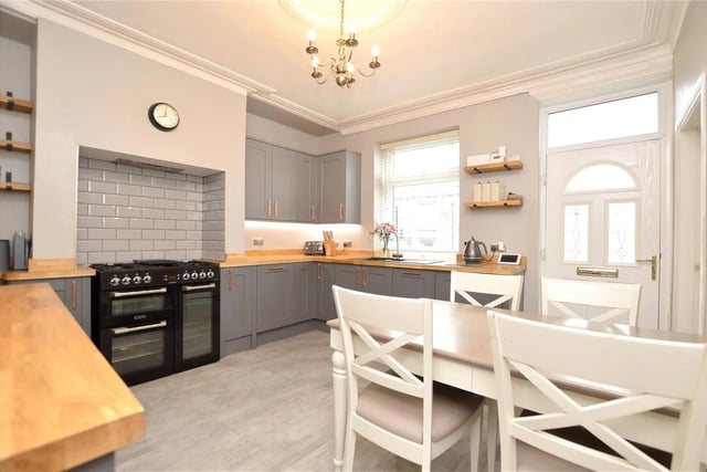 The property features a stunning dining kitchen with a range of dark grey shaker-style fitted units. Featuring integrated fridge, freezer, dishwasher and washing machine as well as two electric ovens.
