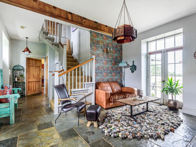 This hall can double as a reception room, with French doors to the gardens.