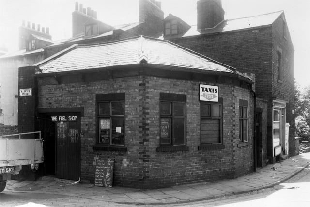 Warwick Street in July 1960. In focus is the Fuel Shop, also an office for Hyde Park Taxis. The Fuel Shop had a variety of goods on offer, catering for customers with open(coal) fires. A list of prices includes a CWT of coal for 7/- (37.5p), coal bricks 2/4d a dozen (slightly less than 25p). Fire lighters, fire wood and paraffin were also for sale. To the right is Little Woodhouse Street, the shop is Moorfield Cleaners,