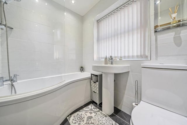 There is a ground floor bathroom with three-piece white suite and over bath shower.