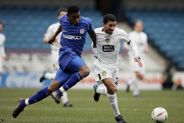 LONDON - MARCH 6:  Marvin Elliott of Millwall tries to tackle Aaron Lennon of Leeds during the Coca-Cola Championship match between Millwall and leeds united at the New Den on March 6, 2005 in London, England.  (Photo by Ian Walton/Getty Images)