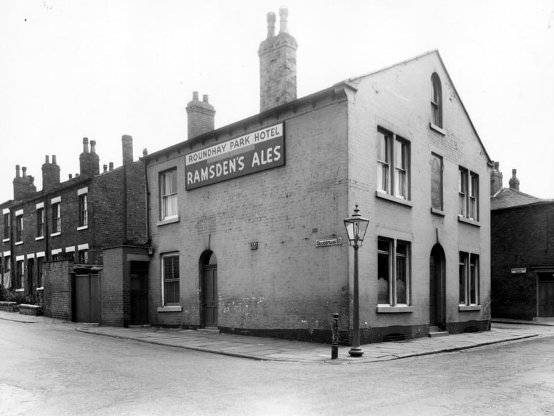 The Roundhay Park Hotel, a Ramsden's public house, situated on Burns Street. To the left is Shakespeare Street, Shakespeare Place can be seen on the right. Pictured in June 1960.