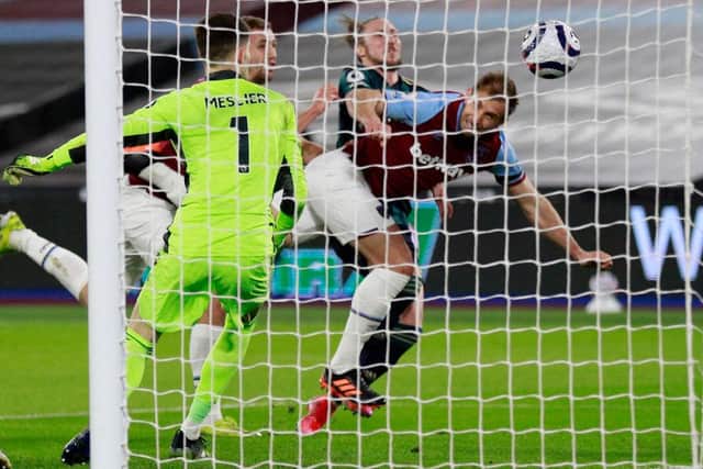 Craig Dawson heads in West Ham's second goal against Leeds United. (Photo by IAN WALTON/POOL/AFP via Getty Images)