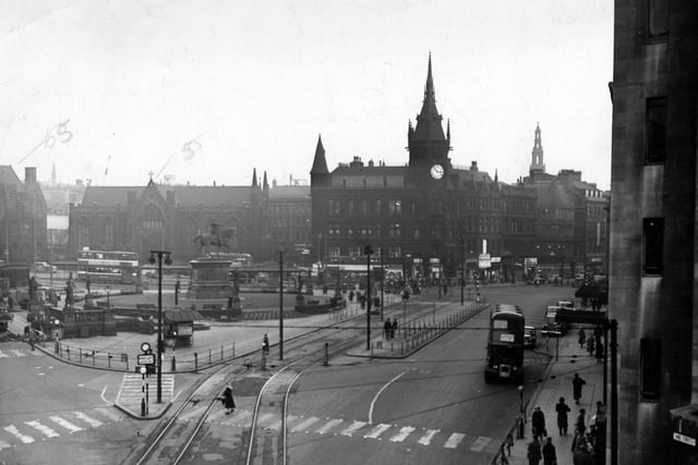 City Square from Wellington Street in January 1956. The Square is dominated by the statue of the Black Prince on his horse. In the background are Mill Hill Chapel and the Royal Exchange Chambers. On the far right part of the Queen's Hotel can be seen. Tramlines are on the road and a bus and several cars are also visible.