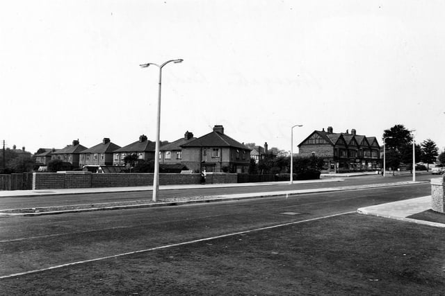 Looking west from Station Road at the backs of houses on Cold Well Road. The brick wall over the road is the top of the railway bridge. Pictured in September 1955.