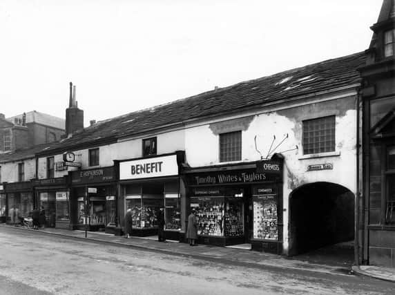 A row of shop properties in Upper Town Street showing the entrance to Hobson's Yard on the right. From left to right the shops number 214 to 202. Two ladies with a coach built pram are chatting outside 210, Arthur M. Abbott's, confectioner. Adjacent, at 208 is E. Hopkinson Ltd, Chemists and Opticians, then at 206, Benefit Footwear Ltd, Boot and Shoe Dealers, Timothy White's and Taylor's Dispensing Chemists at 204. The entrance to Hobson's Yard is wide to allow access to vehicles, carts etc. when it was originally built. Partially seen, far right, is the Midland Bank Ltd at 202 Upper Town Street. Pictured in March 1960.