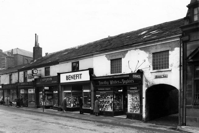 A row of shop properties in Upper Town Street showing the entrance to Hobson's Yard on the right. From left to right the shops number 214 to 202. Two ladies with a coach built pram are chatting outside 210, Arthur M. Abbott's, confectioner. Adjacent, at 208 is E. Hopkinson Ltd, Chemists and Opticians, then at 206, Benefit Footwear Ltd, Boot and Shoe Dealers, Timothy White's and Taylor's Dispensing Chemists at 204. The entrance to Hobson's Yard is wide to allow access to vehicles, carts etc. when it was originally built. Partially seen, far right, is the Midland Bank Ltd at 202 Upper Town Street. Pictured in March 1960.