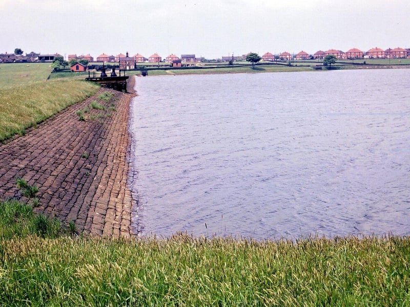 A view along the dam of Ardsley Reservoir, west towards Haigh Moor Road in May 1967.