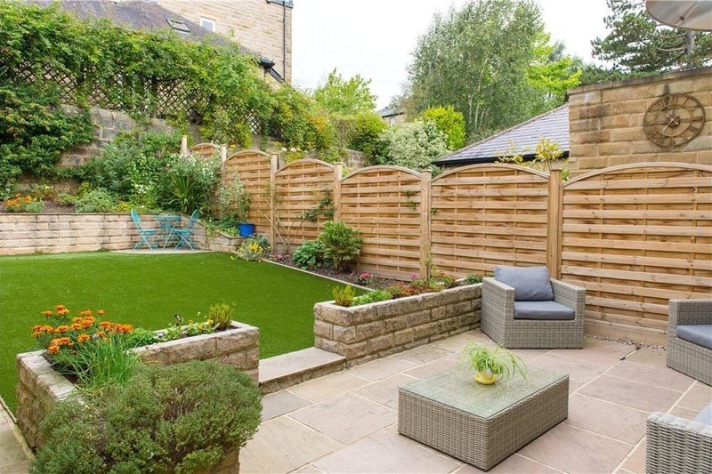 The rear lawned garden, with seating terrace, is private and enclosed.
