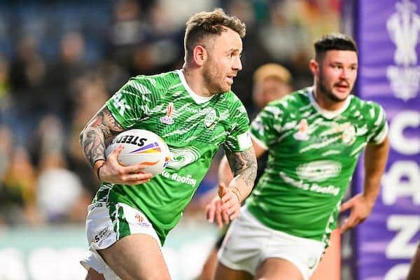 Richie Myler makes a break for Ireland against Jamaica, supported by Rhinos teammate James Bentley. Picture by Will Palmer/SWpix.com.