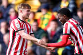 NORWICH, ENGLAND - MARCH 12: Abdoullah Ba of Sunderland celebrates scoring the opening goal with Joe Gelhardt during the Sky Bet Championship match between Norwich City and Sunderland at Carrow Road on March 12, 2023 in Norwich, England. (Photo by Stephen Pond/Getty Images)