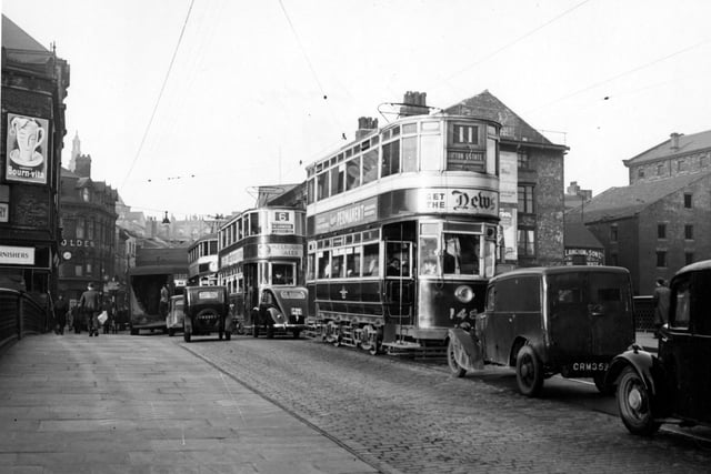 A view looking north from Leeds Bridge onto Briggate in November 1949. The trams include the number 11 to Gipton Estate and number 6 to Meanwood.
