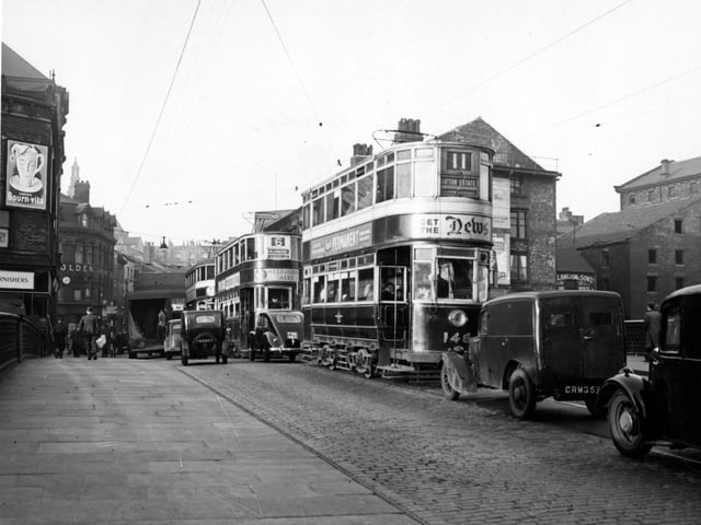 A view looking north from Leeds Bridge onto Briggate in November 1949. The trams include the number 11 to Gipton Estate and number 6 to Meanwood.