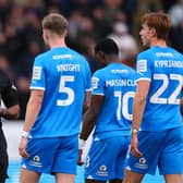 WHITES PRAISE: From Peterborough United midfielder Hector Kyprianou, right, pictured with team-mates Josh Knight and Ephron Mason-Clark in speaking with referee Sam Allison who allowed Leeds United's opener to stand in Sunday's 3-0 victory in the FA Cup third round. Photo by Marc Atkins/Getty Images.
