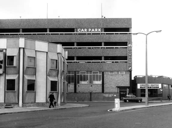 A view of Wade Lane showing the Merrion Centre multi-storey car park in June 1966. To the right is the entrance to the Merrion Centre superstore. Opened in 1964, the Merrion Centre was the first shopping/leisure centre in Leeds, an early example of the mixed-use developments now prevalent in the 21st century.
