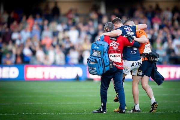 Rhinos' Morgan Gannon is helped from the field after being injured against St Helens. Picture by Allan McKenzie/SWpix.com.