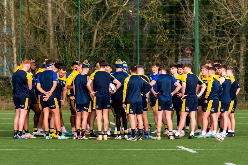 Rhinos' players listen to the coaching staff during a pause in training.