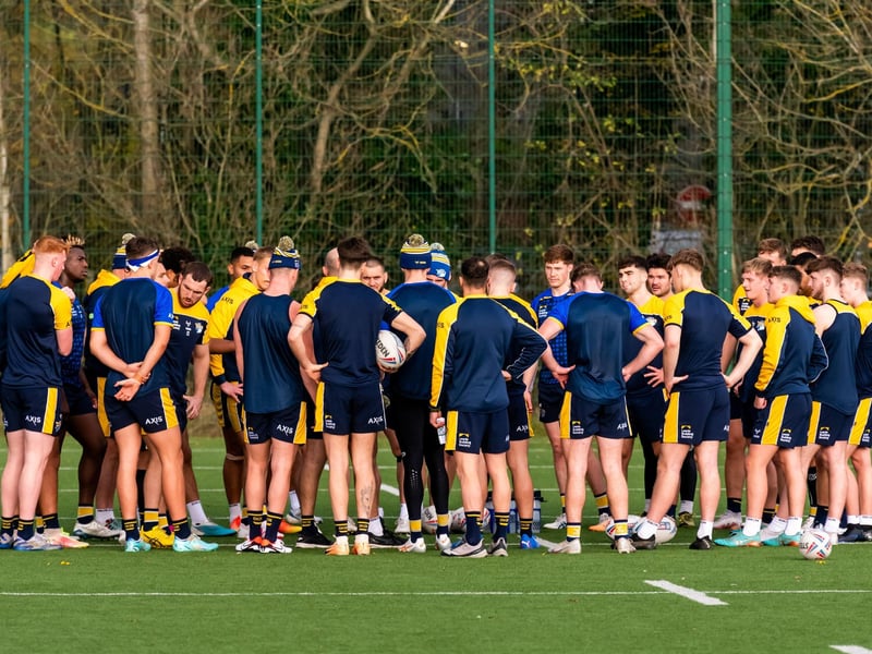 Rhinos' players listen to the coaching staff during a pause in training.