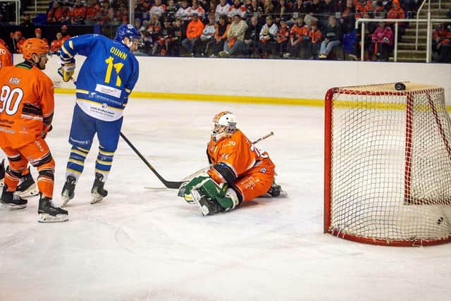 OPENER: Leeds Knights' Sam Dunn watches on as Owen Sobchak (hidden) tips in from in front past goalie Brady Parker (right) to give the visitors the lead at Ice Sheffield on Wednesday night.