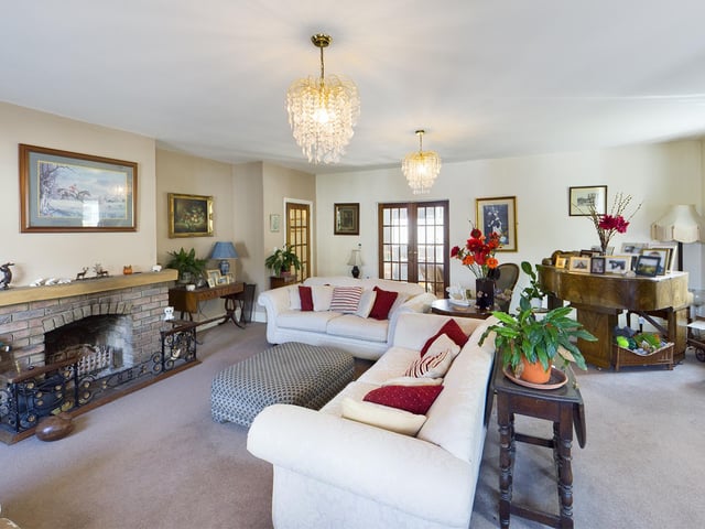 A feature fireplace is central to the comfortable lounge.