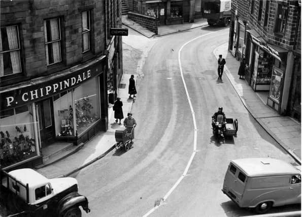 Ivegate in the 1950s. On the left is Paul Chippindale's shoe shop, next chemists shop which was formerly Hardmans then branch of Timothy White and Taylors. Next on the bend of the road, wool shop and Coys corn merchants. To the right, newsagents shop which for years was the business of the White family. Dora White married Sydney Howard, local musical comedy star and comedian. When returning to Yeadon they would stay here with the White family. Last on the right is the Abbey Stores, grocers.