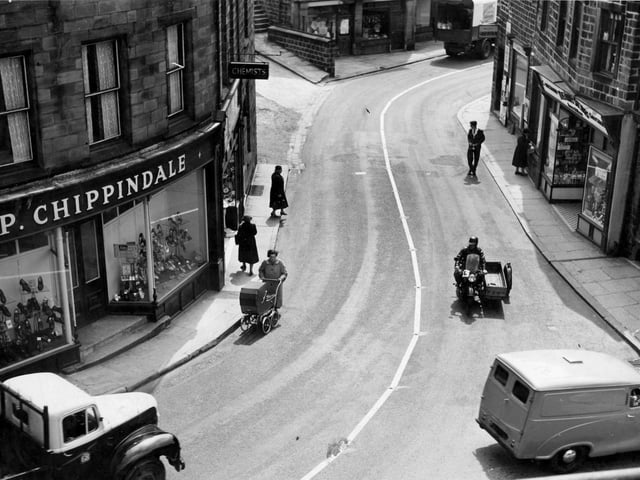 Ivegate in the 1950s. On the left is Paul Chippindale's shoe shop, next chemists shop which was formerly Hardmans then branch of Timothy White and Taylors. Next on the bend of the road, wool shop and Coys corn merchants. To the right, newsagents shop which for years was the business of the White family. Dora White married Sydney Howard, local musical comedy star and comedian. When returning to Yeadon they would stay here with the White family. Last on the right is the Abbey Stores, grocers.