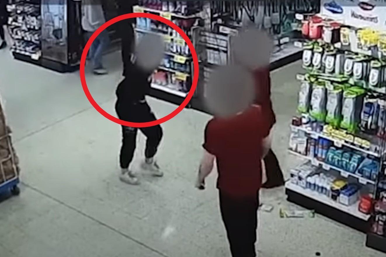 Shocking moment woman spits biscuits at Home Bargains staff member's face after tearing items from shelves