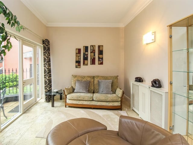 A versatile room with doors leading to an outside patio area.