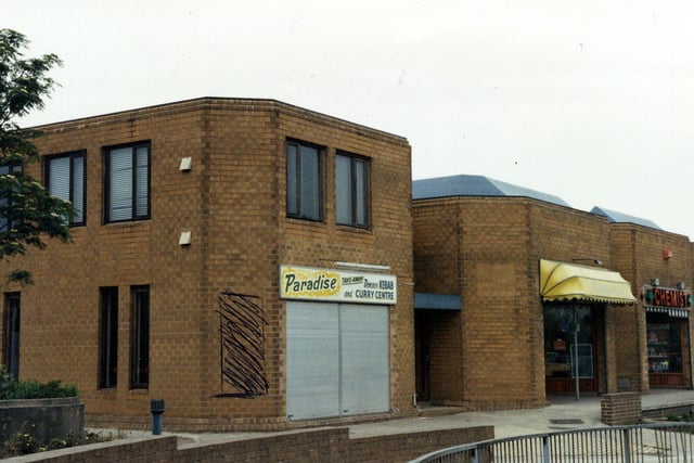 Part of the Fraternity House complex on Church Street in Hunslet, including the Paradise Kebab and Curry Centre in the foreground and a chemist on the right. Pictured in May 1990.