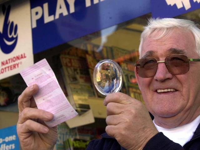 Tom Little, from Castleford, who won the lottery, pictured checking his numbers with a magnifying glass on March 1, 2002.