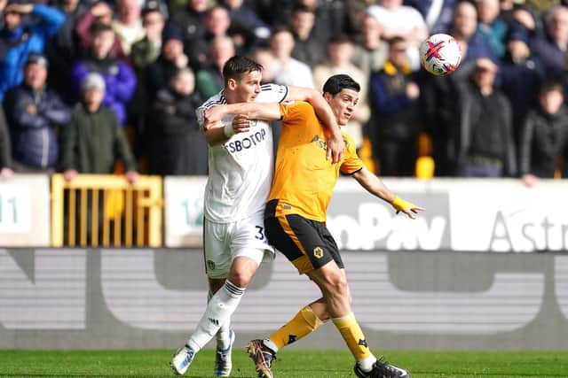 Wolverhampton Wanderers' Raul Jimenez (right) and Leeds United's Maximilian Wober battle for the ball during the Premier League match at Molineux Stadium, Wolverhampton. Picture date: Saturday March 18, 2023.