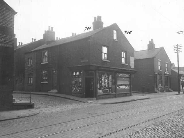 A cobbled Balm Road with tramlines near the junction with Wright Street in September 1935. The shop at number 45 is Bertie Colin Crookson, draper, who has a window display of goods with price tickets.