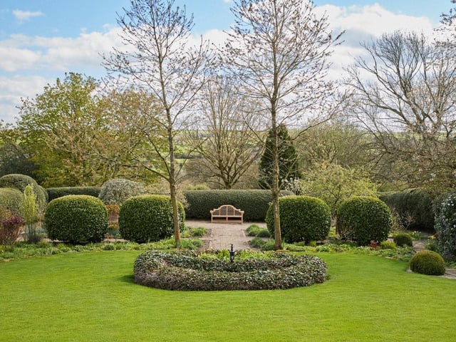 The property is also a haven for gardening enthusiasts. A raised terrace has steps leading down to the south facing mature gardens that are bordered by manicured hedges and layer beds. These give way to a yew parterre with gravel path leading to the lower lawn which extends around the perimeter of the gardens, connecting opposing paddocks and framing either side of the property, creating a natural sense of privacy.