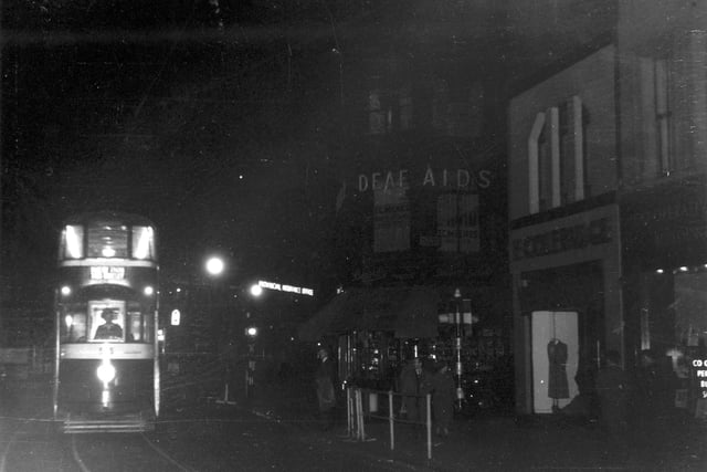 Boar Lane at night in July 1956. Pictured is the last car on route 16 to New Inn, Wortley.