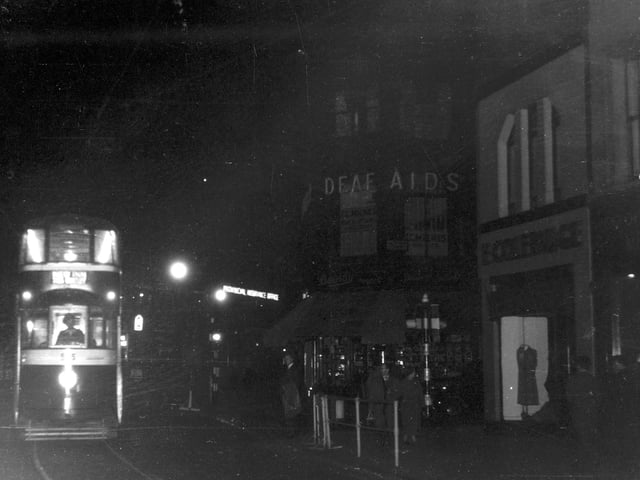 Boar Lane at night in July 1956. Pictured is the last car on route 16 to New Inn, Wortley.