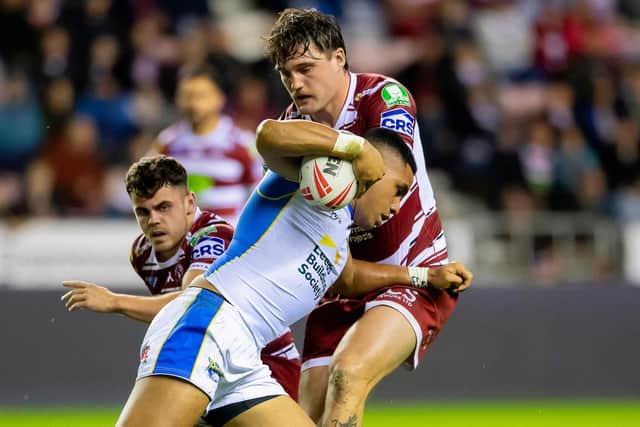 Leeds Rhinos' David Fusitu'a is tackled by Liam Byrne during the defeat at Wigan Warriors. Picture by Allan McKenzie/SWpix.com.