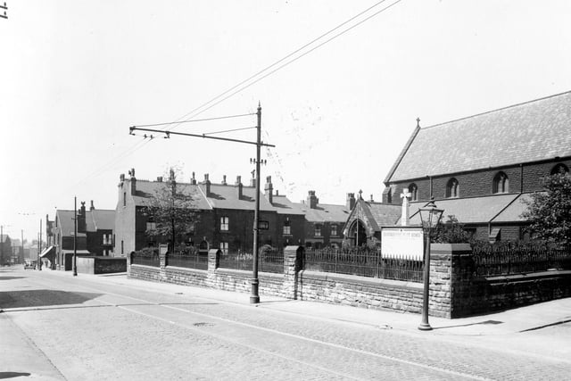 St. Agnes Church on Stoney Rock Lane in June 1939. The street to the left of the church is Rock Square, to the right Spink Road. The church was built in 1889, it cost £5,000. In Gothic style it was designed by architects Kelly and Birchall of Leeds. The reredos was given by the Burmantofts Pottery works. It was of Terra-cotta facience, for which the company was renowned.