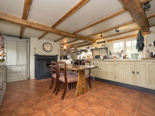 The kitchen has a full range of units, and ample space for dining table and chairs.