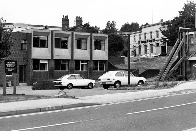 Burley Liberal Club and car park at the junction of Willow Lane, visible in the foreground and Burley Road. On the right the large warehouse premises of Alf Harrison & Son's Ltd., carton manufacturers on Burley Road are visible. Pictured in July 1979.