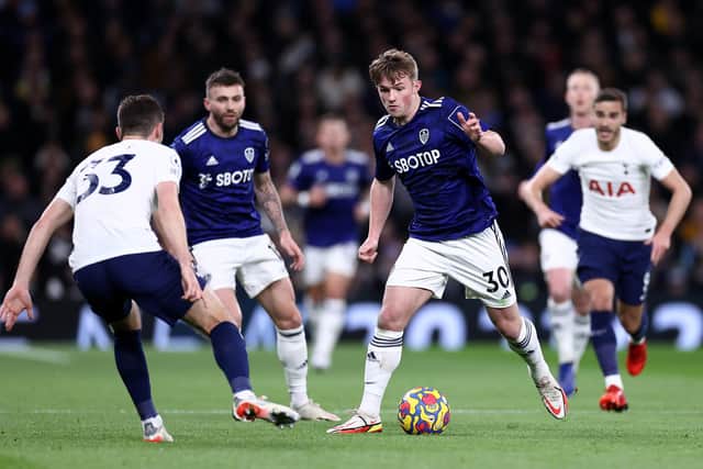 Joe Gelhardt of Leeds United runs with the ball whilst under pressure from Ben Davies of Tottenham Hotspur during the Premier League match between Tottenham Hotspur and Leeds United at Tottenham Hotspur Stadium. (Photo by Ryan Pierse/Getty Images)