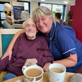 A Care 24-7 carer shares a smile and a cup of tea with a client during the company's successful Yorkshire Day celebration, which was supported by Morrisons and Yorkshire Tea