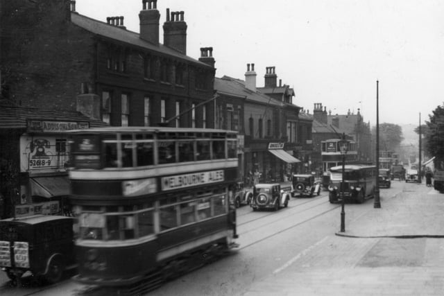 A stretch of Otley Road, looking towards North Lane in June 1937. On the left, with telephone sign on wall is the fish shop of William Addison. Further to the right, shop with blind down is Groocock and Son, grocers.
